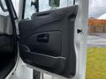 A 2017 International WorkStar 7600 truck door is shown in an open position featuring a black interior panel with a handle and a window control switch
