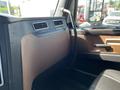 A 2022 Freightliner Cascadia interior showing the dashboard and brown trim with visible air vents and controls