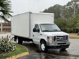 A 2022 Ford Econoline white box truck is parked at an angle with its box compartment visible and the front grille prominently displayed