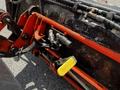 A close-up view of the hydraulic controls on a 2011 Kubota M8540D tractor featuring levers and connectors in orange and black metal