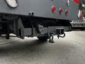 Close-up of the rear hitch of a 2020 Ford F-350 SD featuring a receiver hitch and two safety chain hookups