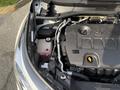 A 2021 Toyota C-HR engine compartment showing the engine cover battery and various fluid reservoirs and hoses