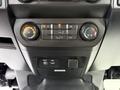 Interior controls of a 2015 Ford F-150 including climate control knobs and a USB port