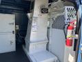 Interior view of a 2008 Ford E-350 van featuring storage compartments and a fire extinguisher mounted on the wall