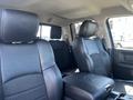 Interior view of a 2011 RAM 1500 showing black leather and fabric seats with a center console between the front seats