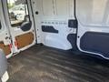 Interior of a 2010 Ford Transit Connect with a clear floor space and metal side panels visible
