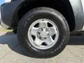 Close-up of a silver wheel and tire from a 2015 Toyota Tacoma showcasing the tire tread and alloy wheel design