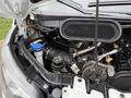Under the hood of a 2017 Ford Transit showcasing the engine components including the coolant reservoir and serpentine belt system