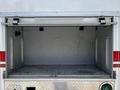 Empty compartment of a 2009 Ford F-550 with metallic flooring and side rails