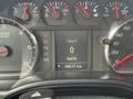 Dashboard of a 2016 GMC Sierra 1500 displaying speed of 0 km/h and odometer reading of 58672 km with various gauges for RPM temperature and fuel levels