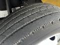 A close-up of a tire from a 2006 Hino 268 showing tread patterns and wear on the surface