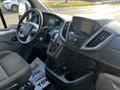 Interior of a 2017 Ford Transit featuring a steering wheel dashboard and control console with various buttons and screens