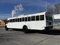 A 2022 Blue Bird Vision school bus with a white exterior and black wheels parked on a street