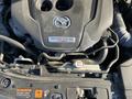 The image shows the engine of a 2023 Mazda MAZDA3 featuring the SKYACTIV-G Turbo label with various hoses and components visible around it