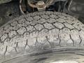 Close-up of a worn tire from a 2019 Ford F-150 showing significant tread wear and dirt accumulation