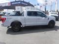 A white 2022 Ford F-150 pickup truck with a black truck bed liner and dark alloy wheels shown from the side