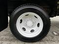 Close-up of a white wheel and tire from a 2018 Isuzu NRR showcasing the tire brand Kumho and distinctive wheel design