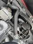Close-up of the engine compartment of a 1970 Chevrolet Corvette featuring various mechanical components including hoses and a pulley system