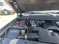 Engine compartment of a 2016 Chevrolet Tahoe displaying the engine components and various hoses and fluid reservoirs