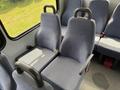 Interior seating of a 2017 Chevrolet Express with fabric-covered seats and seatbelts visible
