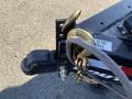 Close-up of a 2024 Southland 18 Foot Dump Trailer showing the hitch with a ball coupler and a gold hook for securing the trailer
