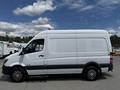 A 2016 Mercedes-Benz Sprinter van in white with gray accents and alloy wheels viewed from the side