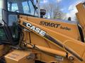 A 2005 Case 570MXT turbo tractor featuring an orange hydraulic arm with the CASE logo prominently displayed