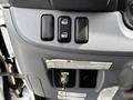 Control panel of a 2015 Mitsubishi Fuso FE featuring window controls and a warning indicator