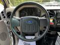 Steering wheel of a 2009 Ford F-550 showing the Ford logo with dashboard gauges and controls visible in the background