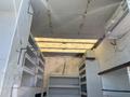 2008 Ford F-450 SD with an empty cargo area featuring metal shelving and storage compartments along the sides