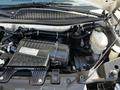 View of the engine compartment of a 2019 Chevrolet Express showcasing the Vortec engine along with various components such as the oil filter and coolant reservoir