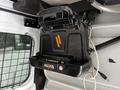 A black Havis docking station mounted on a wall with visible ports and connectors designed for a 2016 Ford Transit Connect