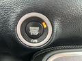 Close-up of the engine start-stop button in a 2017 Dodge Challenger showing the text ENGINE START STOP illuminated in orange