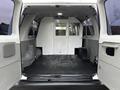 Interior view of a 2011 Ford Econoline showing an empty cargo space with a flat floor and no seats