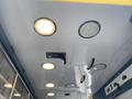 Interior ceiling of a 2014 Chevrolet Express with multiple round light fixtures and a rectangular handle in the center