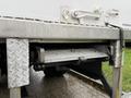 A side view of a step and support structure on a 2017 Freightliner M2 106 truck showcasing a metallic design with a diamond pattern