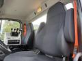 Interior of a 2016 Freightliner 108SD featuring two large black fabric seats and a control panel with various levers and buttons