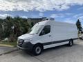 A 2019 Mercedes-Benz Sprinter van in white with a black lower section and refrigeration unit mounted on the roof