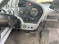 Dashboard of a 2015 Global Street Sweeper with various gauges knobs and a control panel for the vehicle's operations
