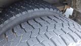 A close-up view of a tire on a 2011 Ford Econoline showcasing the tread pattern and rubber surface