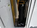 A 2013 Chevrolet Express with a visible lift mechanism featuring a black strap and metal platform within its entryway