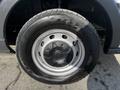 Close-up of a wheel from a 2018 Ford Transit featuring a silver steel rim and a black tire with visible tread pattern and brand markings