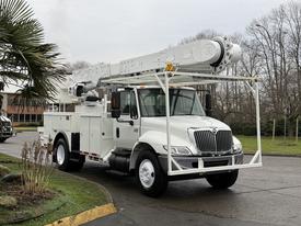 A white 2007 International 4200 utility truck with an elevated aerial lift system mounted on top and a service body equipped for maintenance tasks