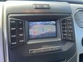 A dashboard display screen showing a rearview camera view with guidelines and various control buttons for a 2014 Ford F-150