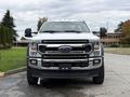 A 2022 Ford F600 is parked facing forward featuring a silver and chrome front grille with the Ford logo prominent and large side mirrors