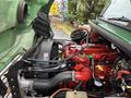 The image shows the engine of a 2015 Freightliner M2 106 with visible red and black components including hoses and a fan assembly