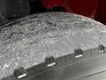 Close-up of a worn tire tread showing cracks and dirt on a 2011 International 4400 vehicle