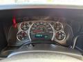 Dashboard of a 2020 Chevrolet Express showing speedometer fuel gauge and various warning lights with odometer reading 223896 km and temperature display at 18 degrees Celsius