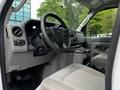 Interior view of a 2021 Ford E-450 showcasing the steering wheel dashboard and seats