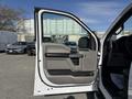 2018 Ford F-150 with an open driver side door showcasing the interior door panel and handle